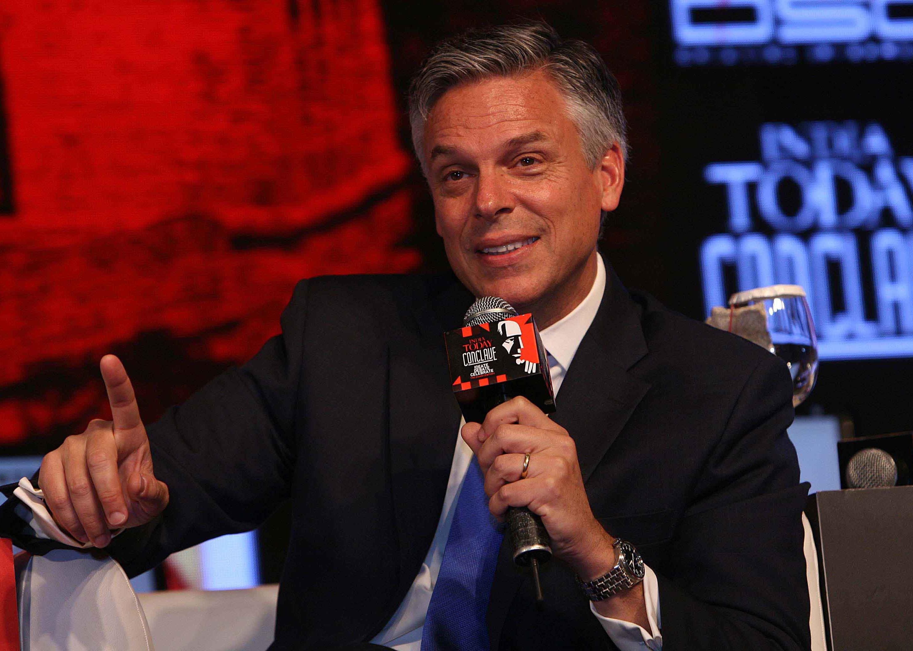 John Huntsman Jr. speaking in a studio with a microphone.