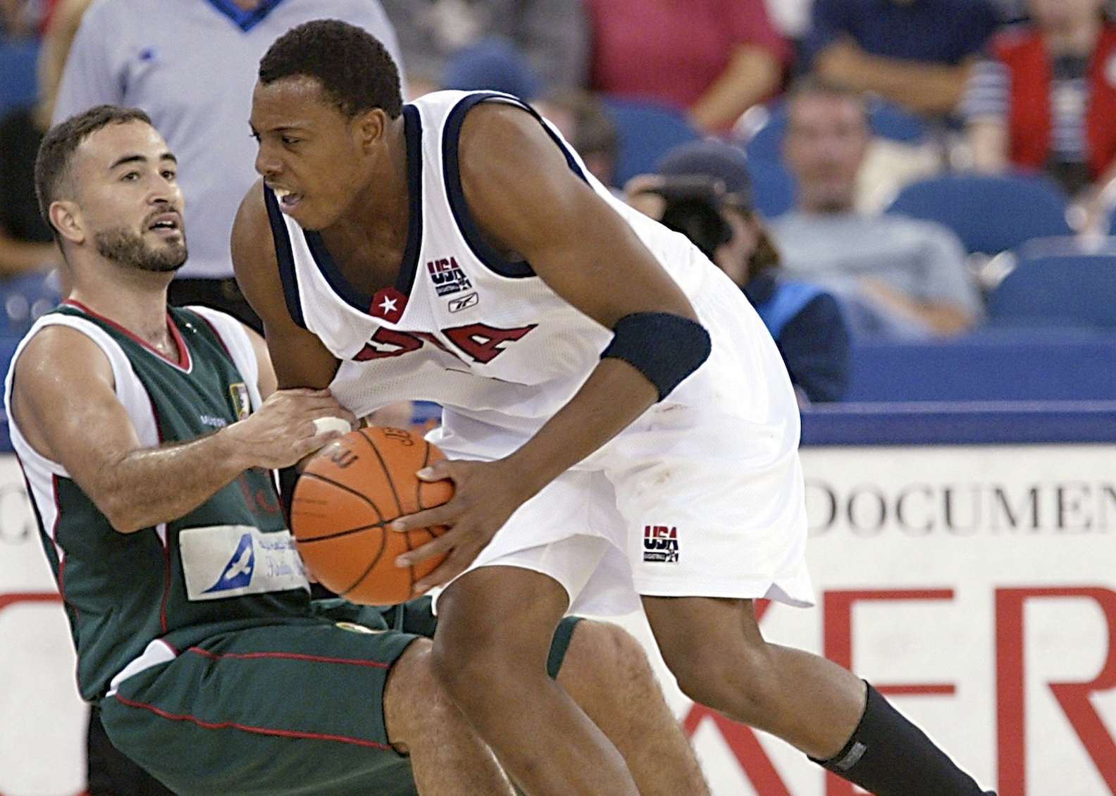 Paul Pierce of the US runs by Amine Benramdane of Algeria.
