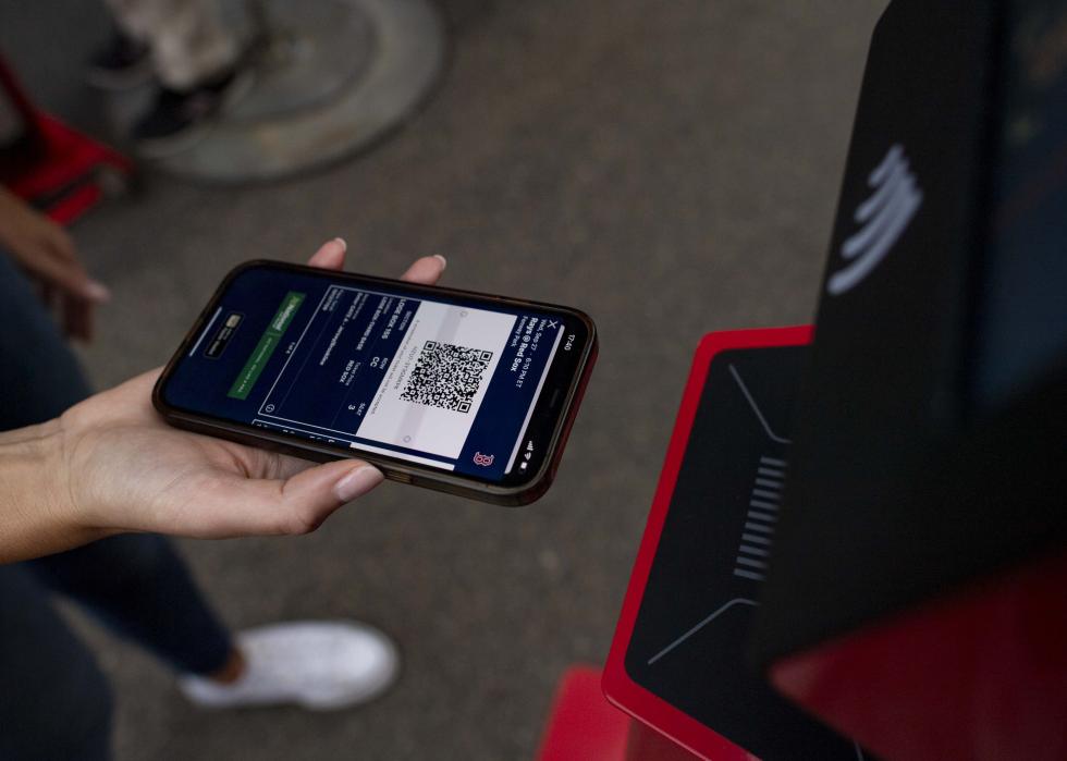 A fan presenting a digital ticket at a kiosk.