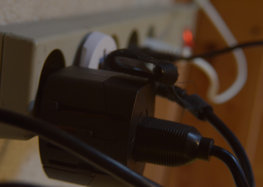 Cords plugged into a full surge protector.