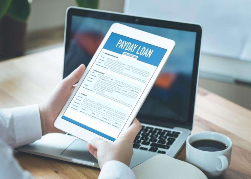 A person filling out a digital loan application.