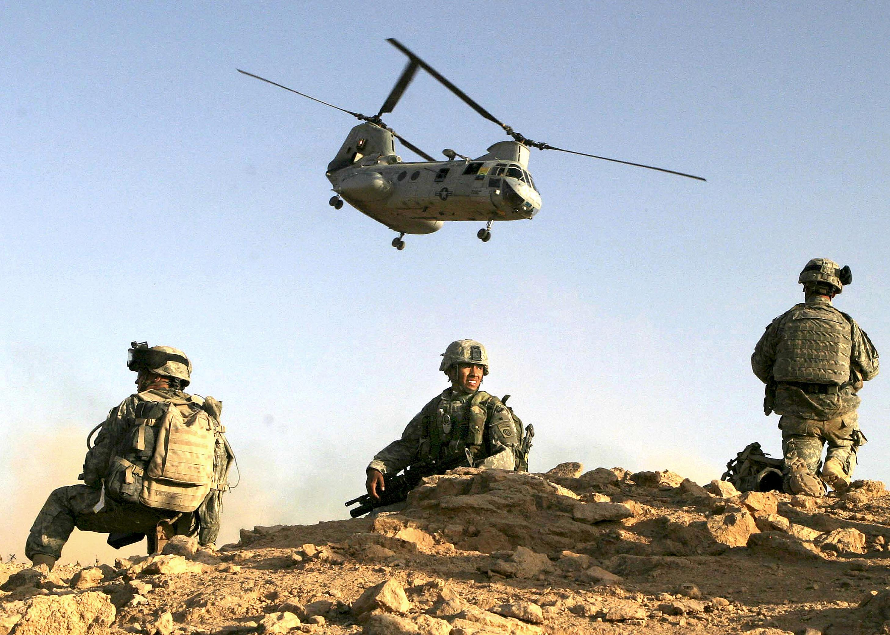 Soldiers setting up security after landing in the desert in Baghdad.