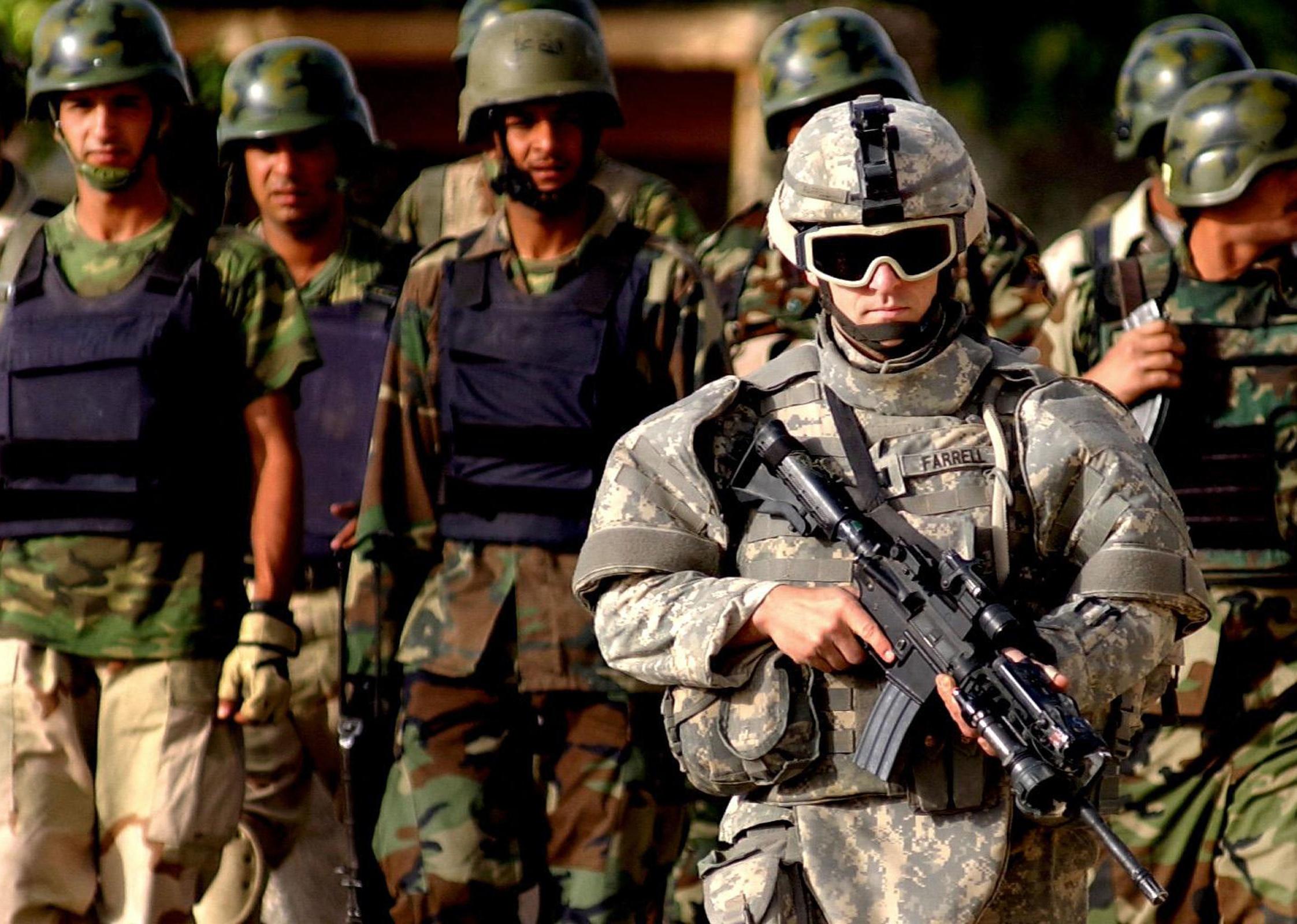 A US soldier leading a platoon of Iraqi Police Officers in Samarra.