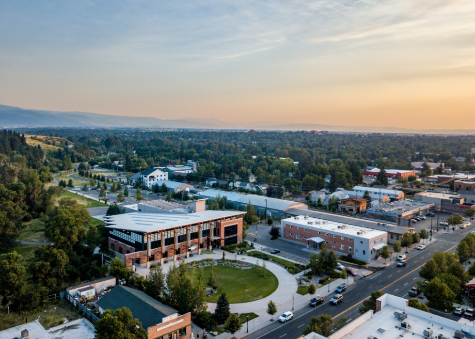 An aerial view of a town with mountains in the distance.