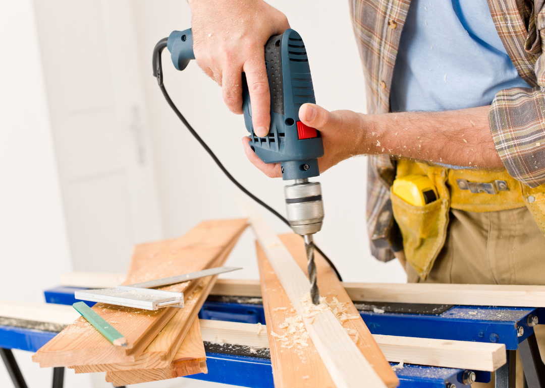 Close up of a person drilling wood.