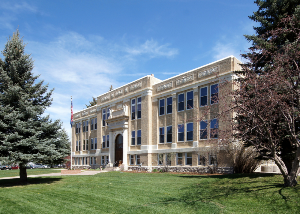 A large building with an American flag out front. 