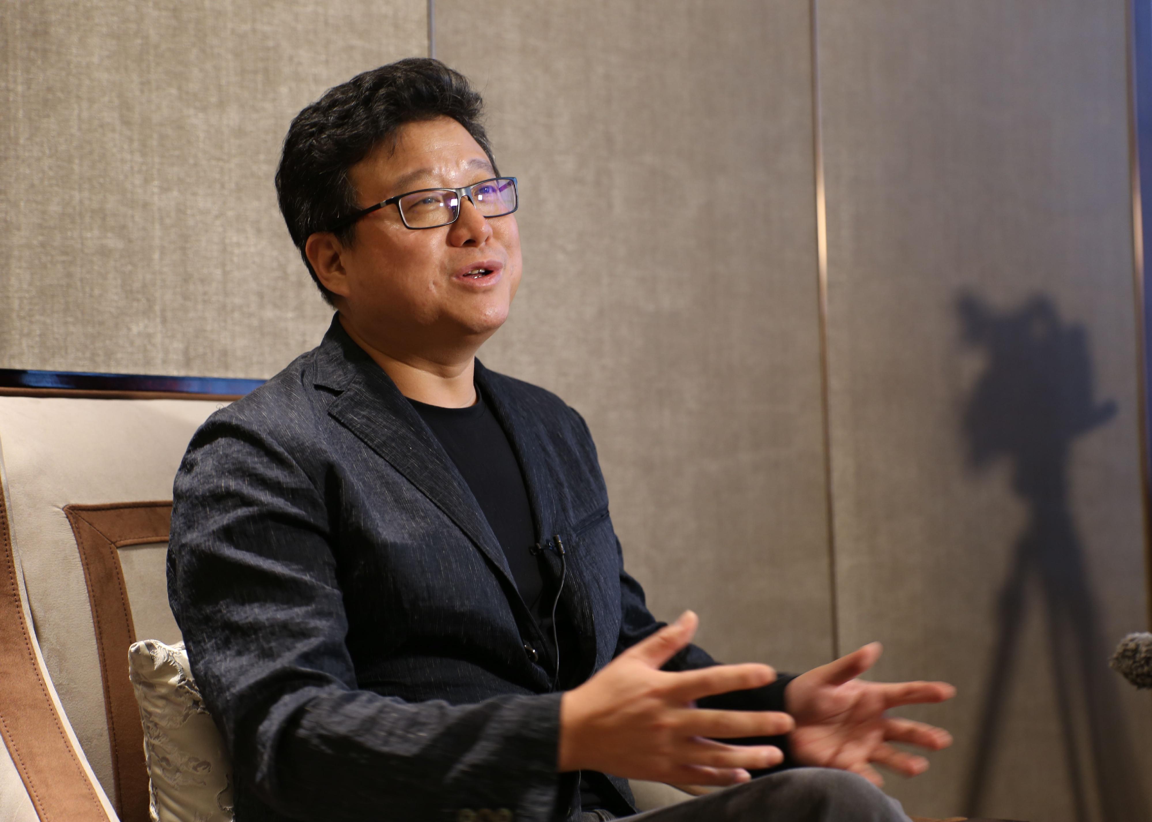 William Lei Ding speaks at event.