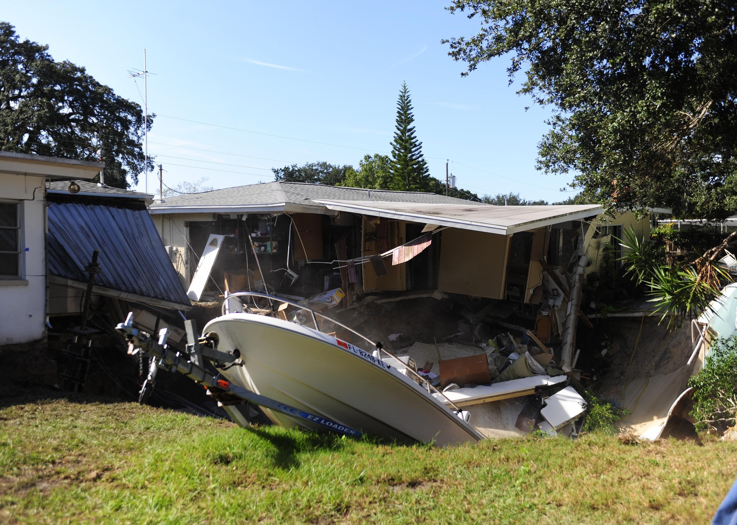 The rear portion of a residential home is consumed by a sinkhole