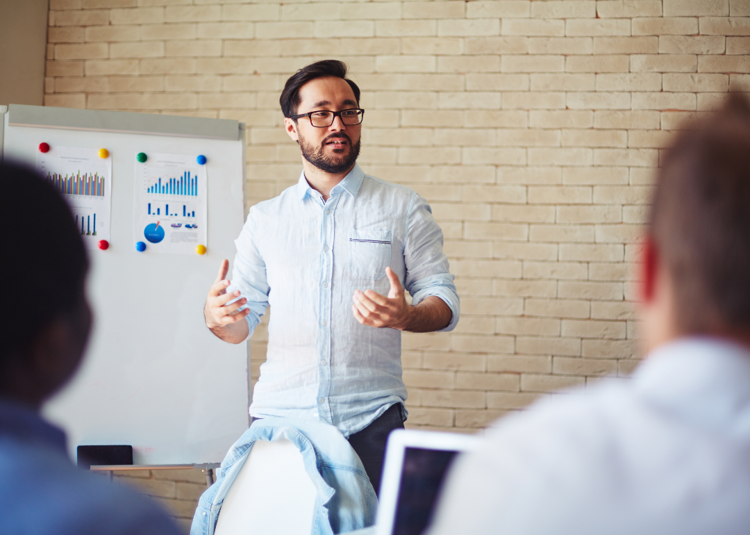 A man teaches a class with students.