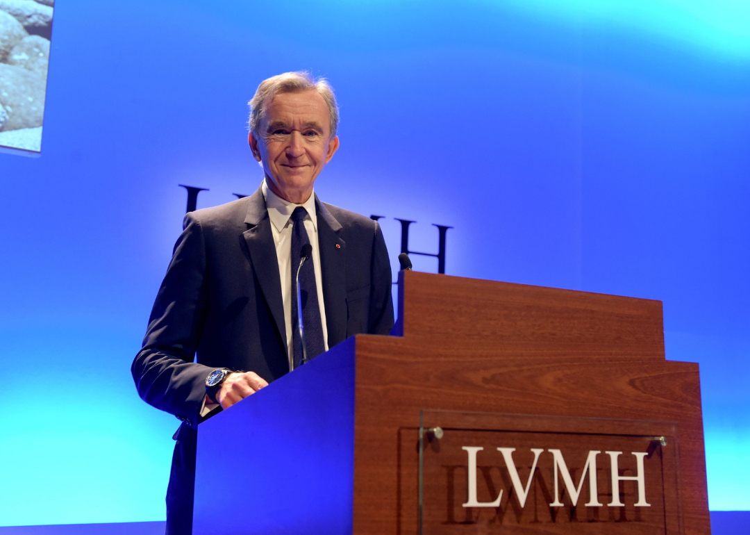 Bernard Arnault stands at podium.