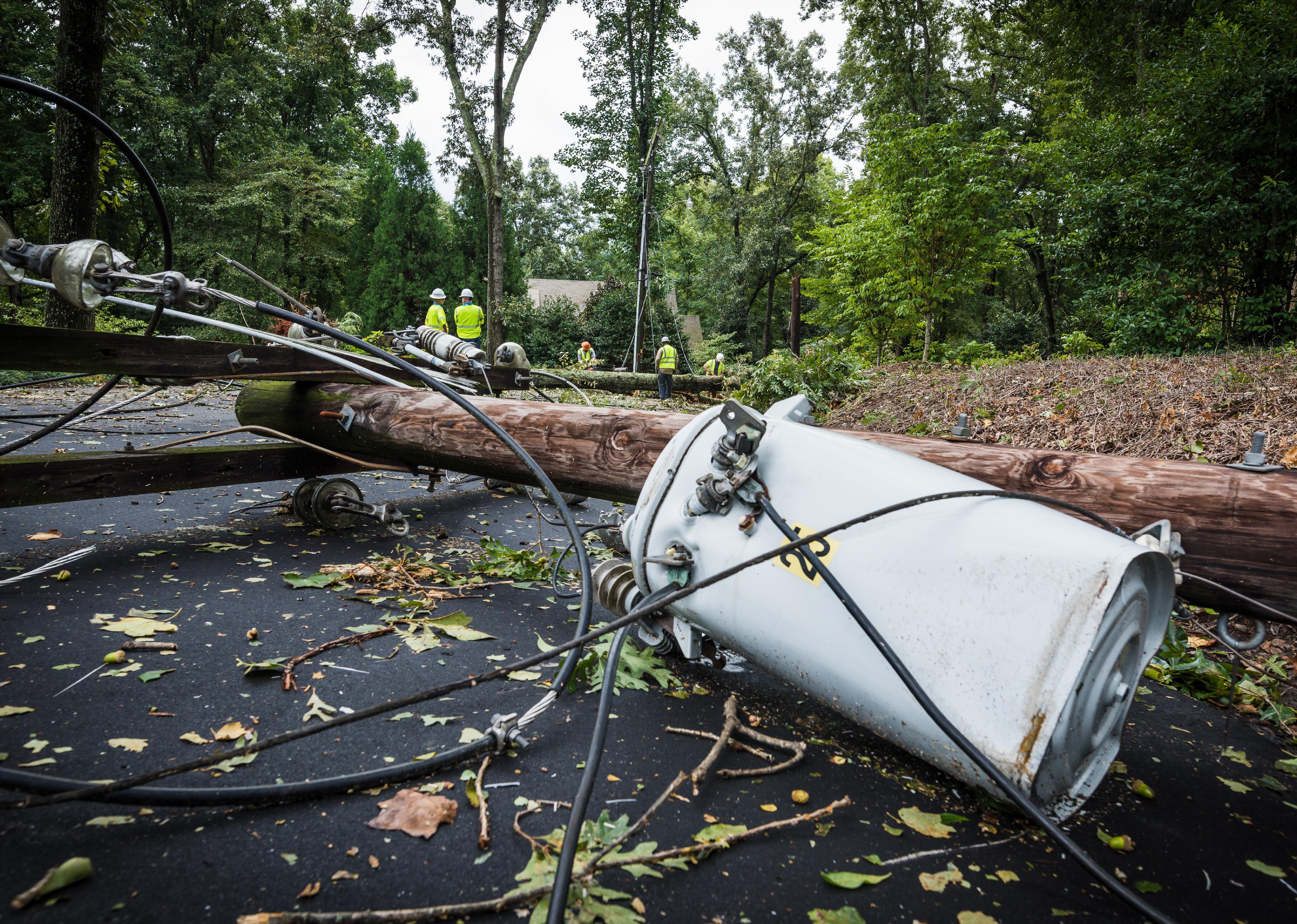 Down power lines and electric equipment in residential neighborhood.
