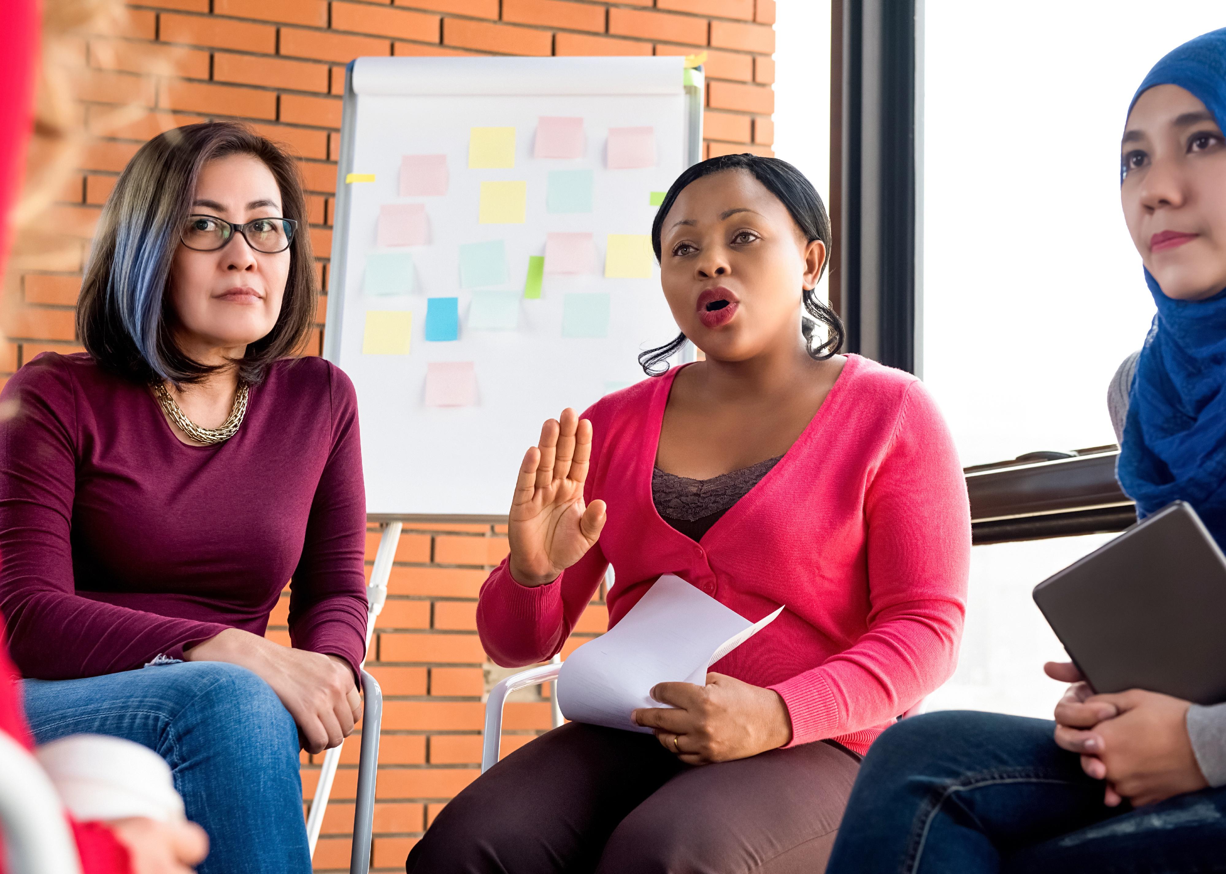 Women in a circle in a group meeting.