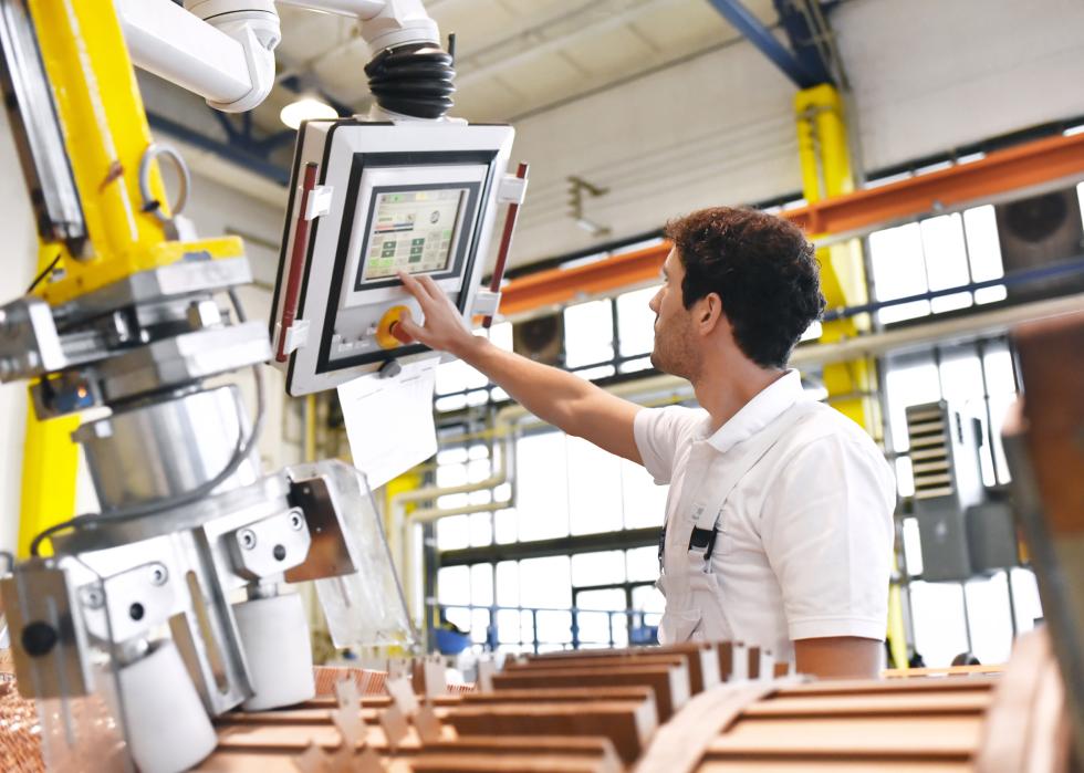 Mechanical worker operates a machine for winding copper wire