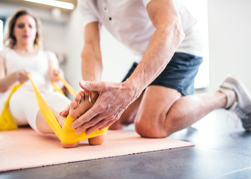 Physiotherapist working with a female patient.