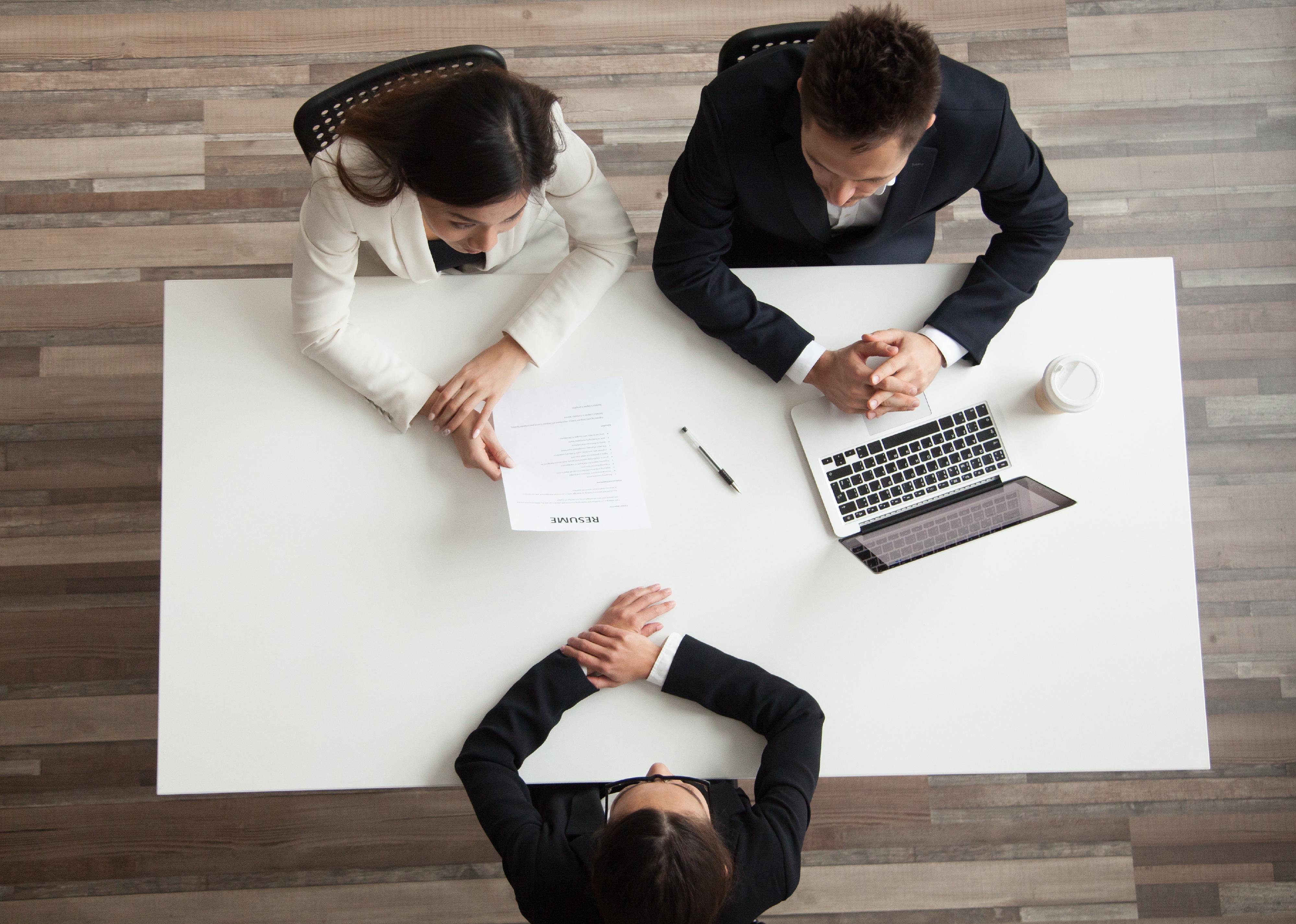 Top view of HR managers interviewing job applicant