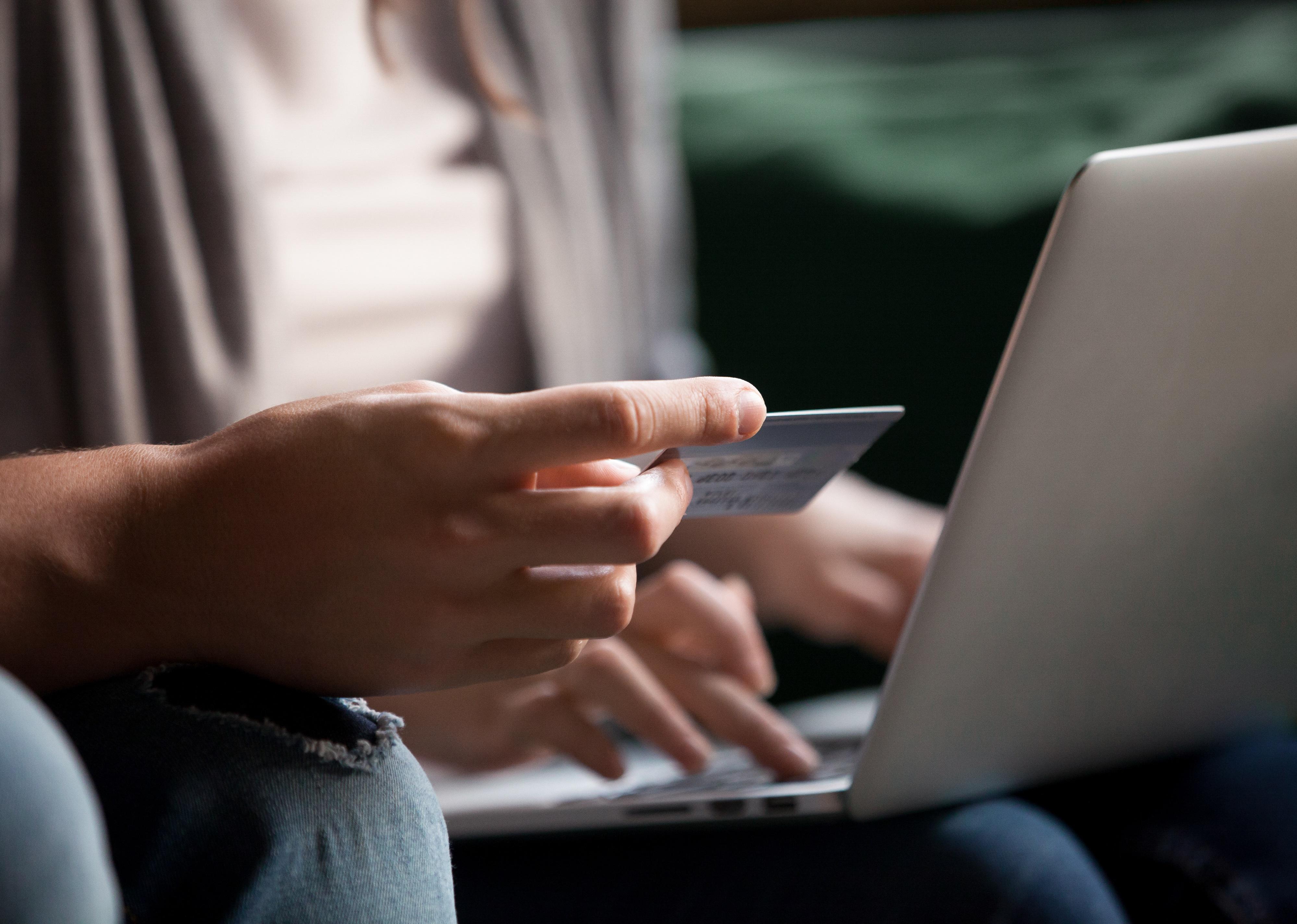 Close-up view of hand holding credit card
