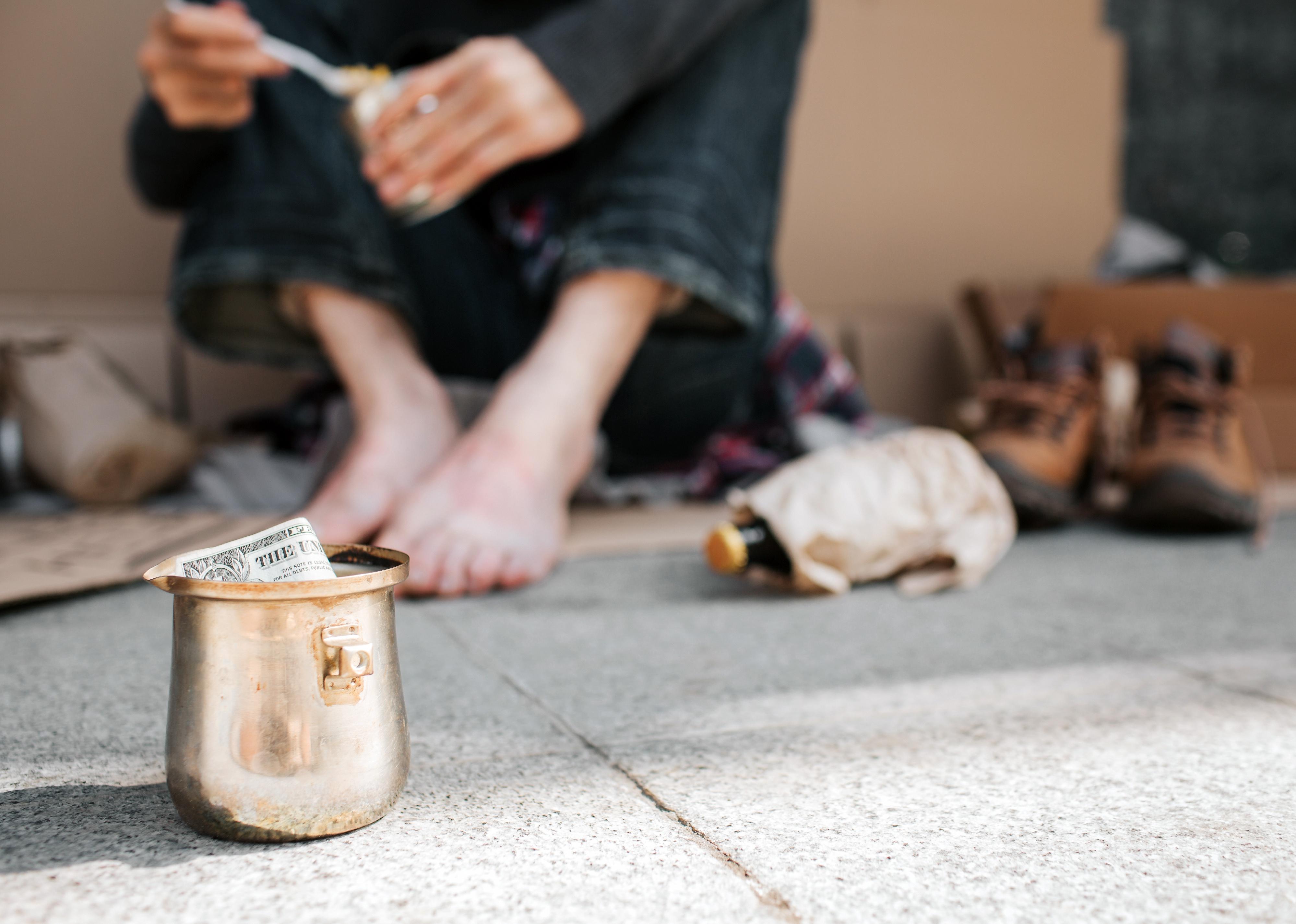 A picture of a cup standing on concrete ground. 