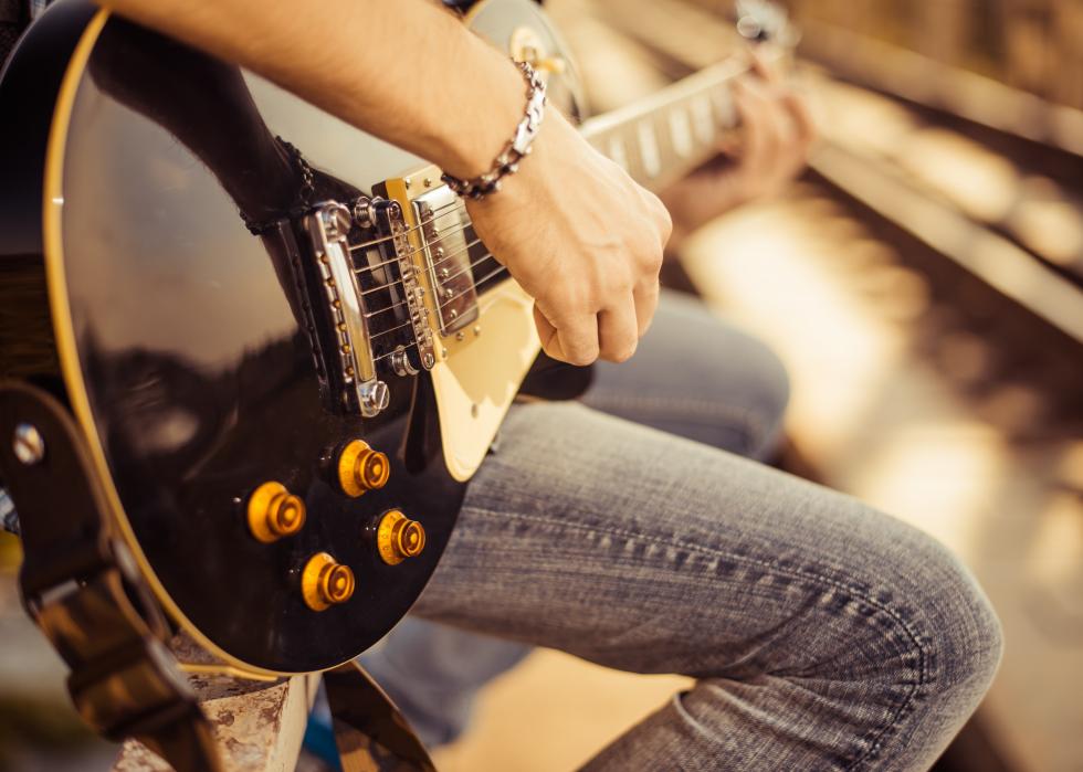 Close up of guitarist playing a song