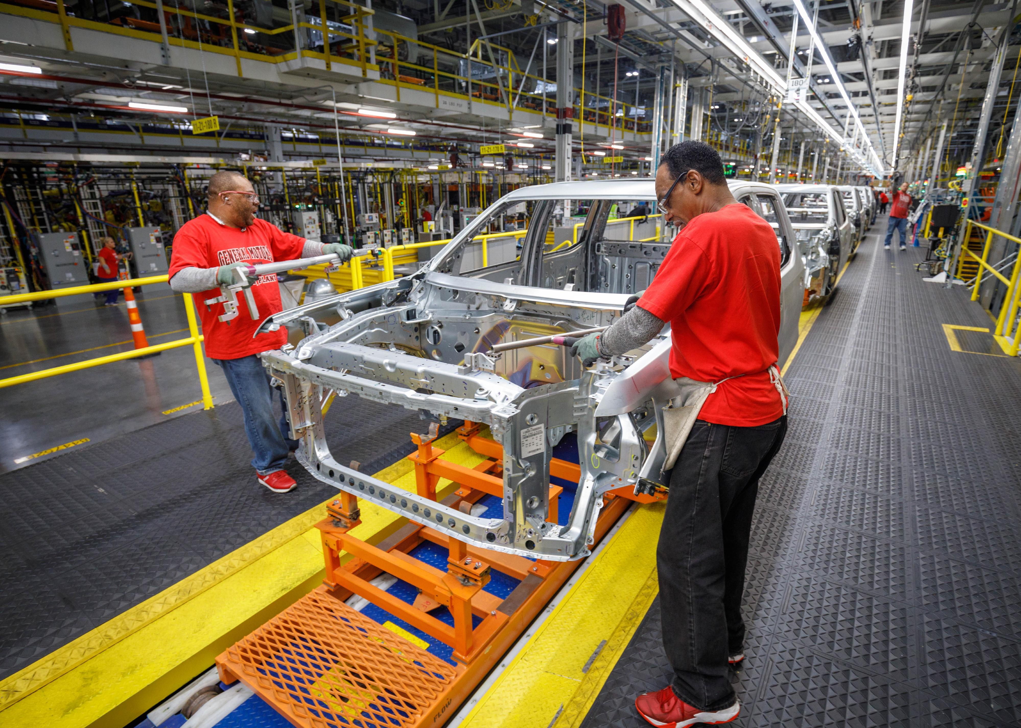 Workers in a car body shop