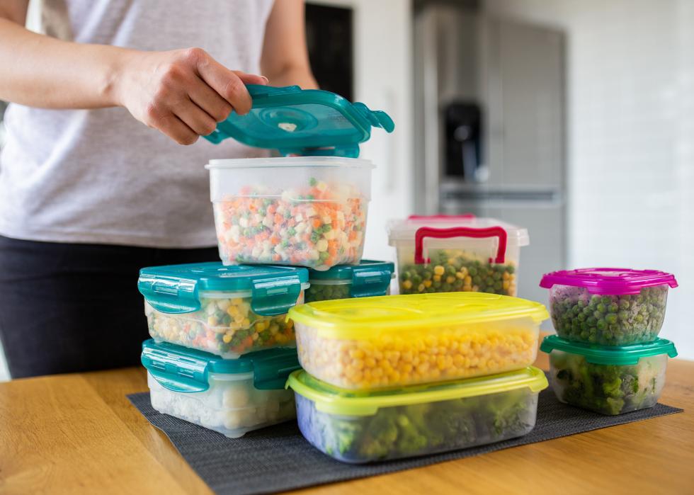 Woman preparing containers with vegetables