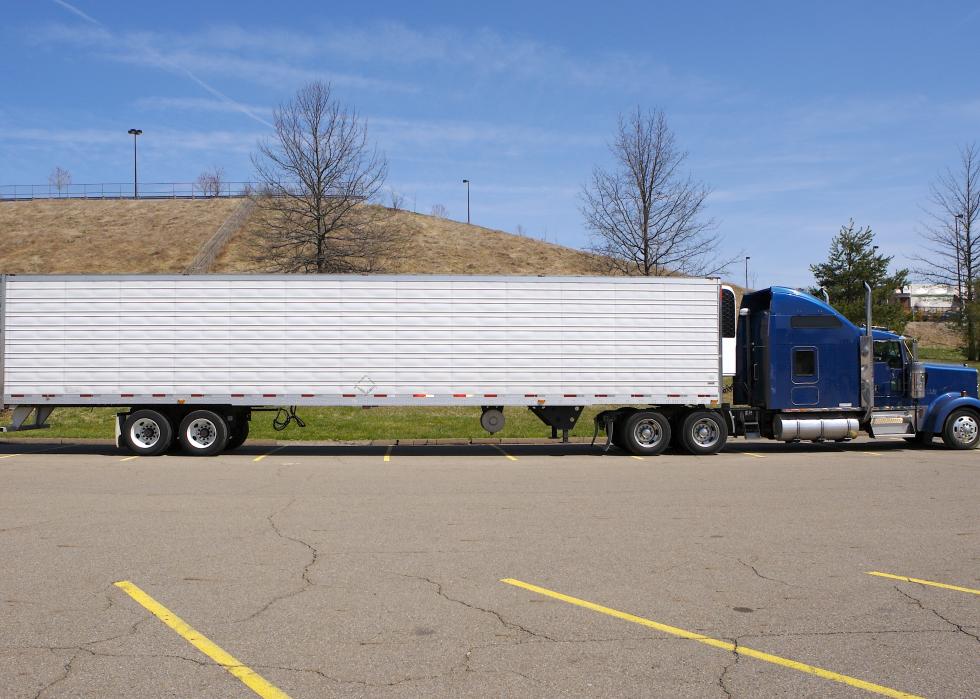 Semitruck parked sideways in a lot.