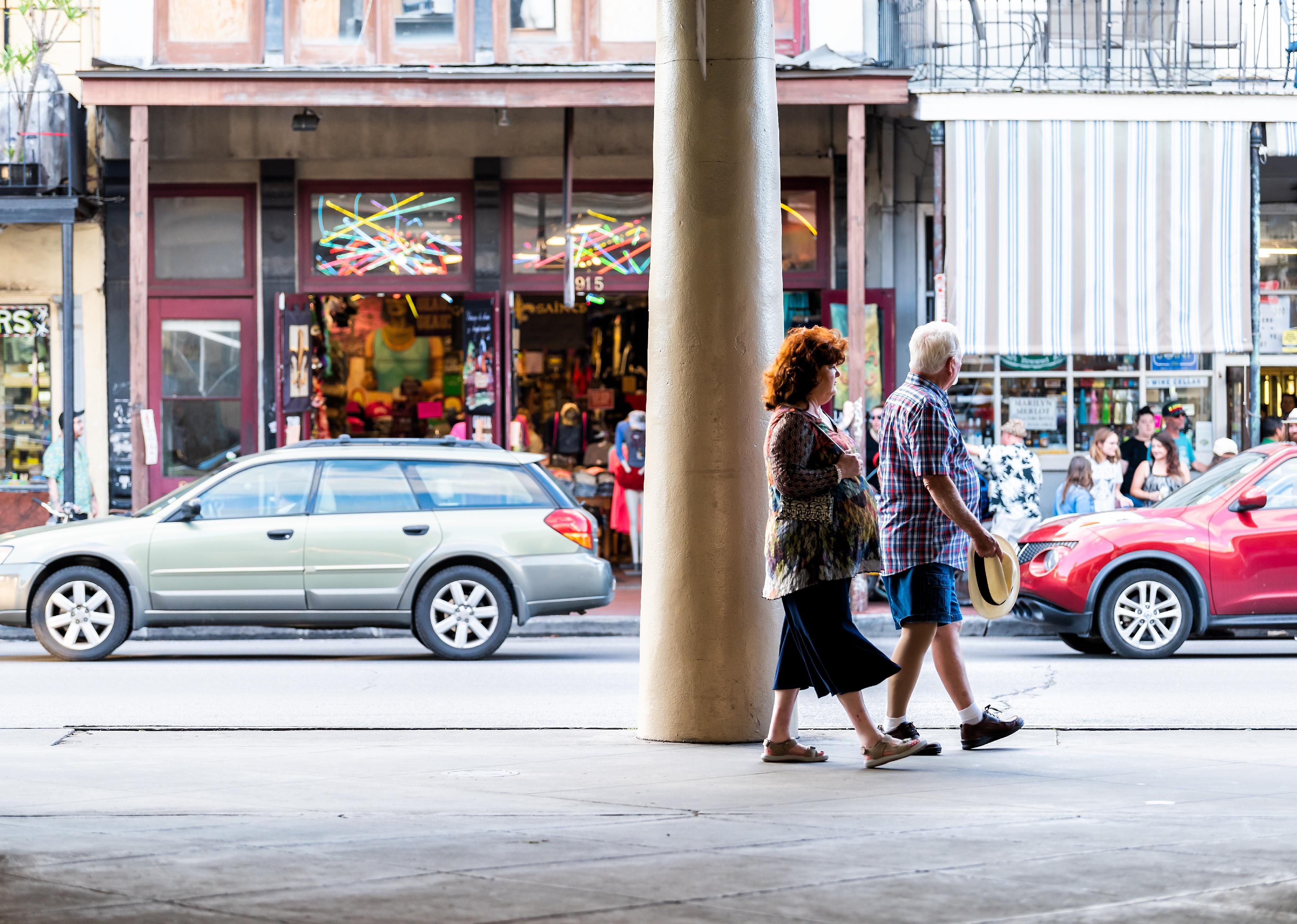 Couple walking by stores in downtown New Orleans.