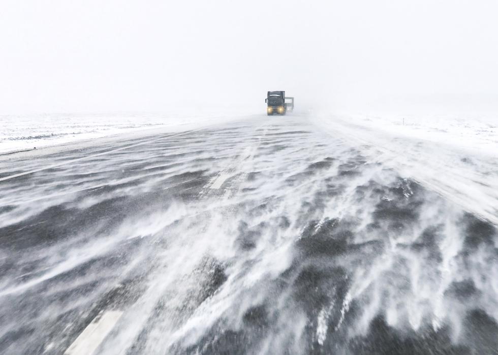 Traffic on highway in snow blizzard.