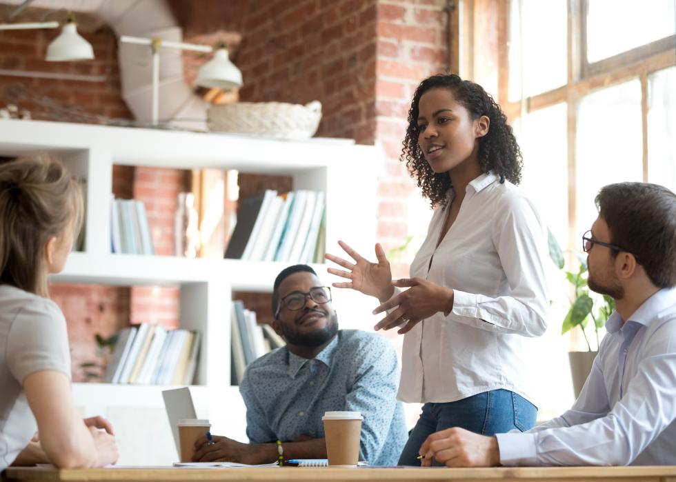 Black female employee speaking at a meeting