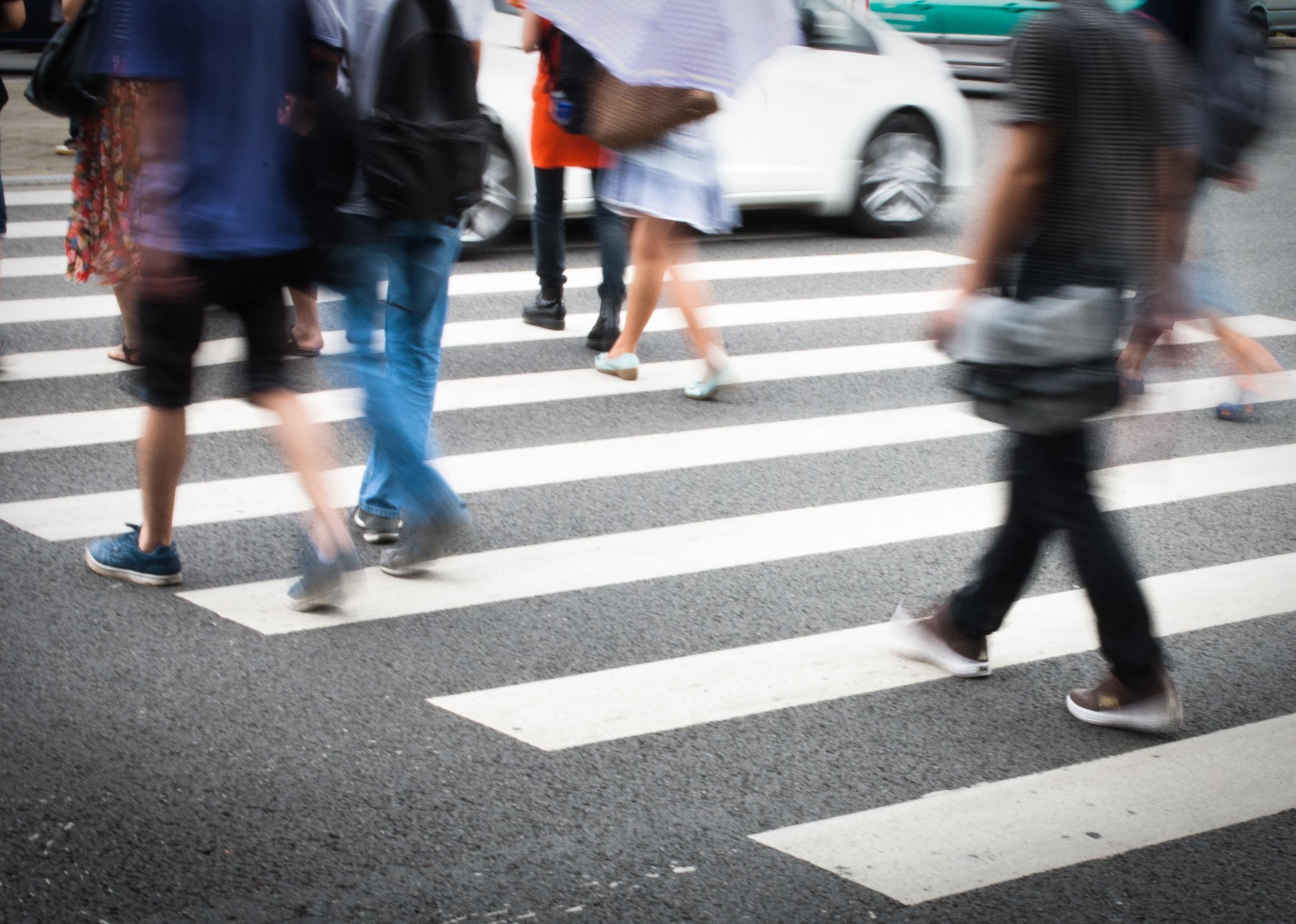 Busy city street with people on crosswalk