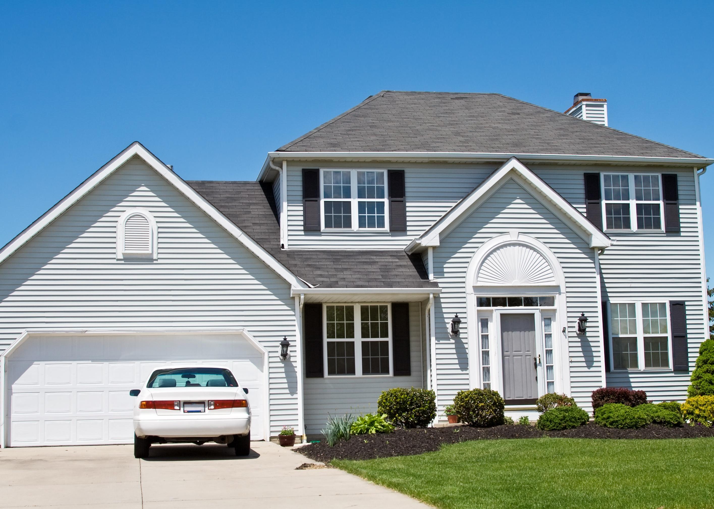 An American Ohio suburban home with one car in the driveway.