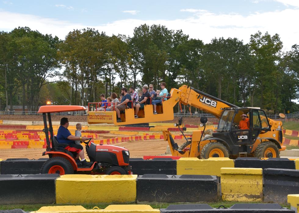 Families operating construction equipment at Diggerland.