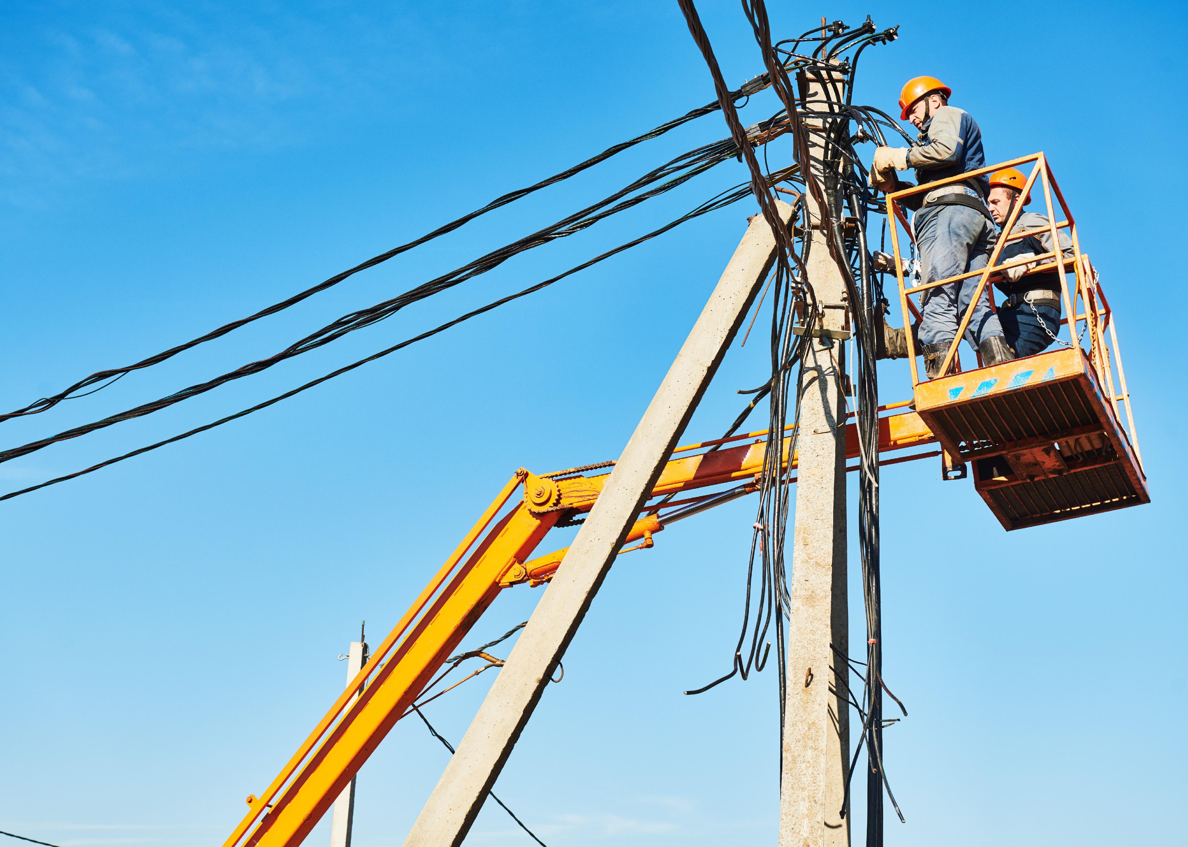 Power lineman at work on a electric pole.