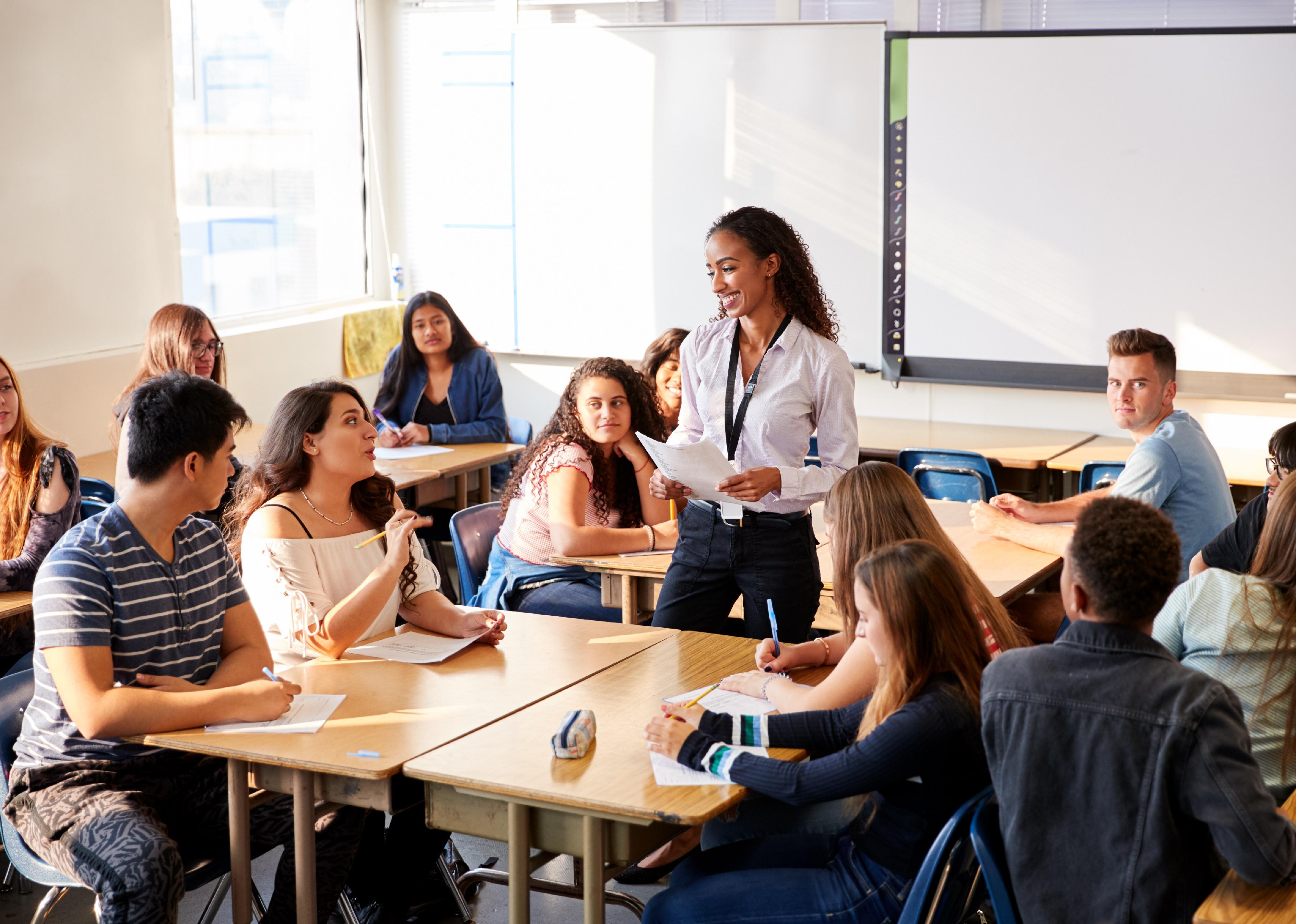 Female high school teacher standing teaching a lesson