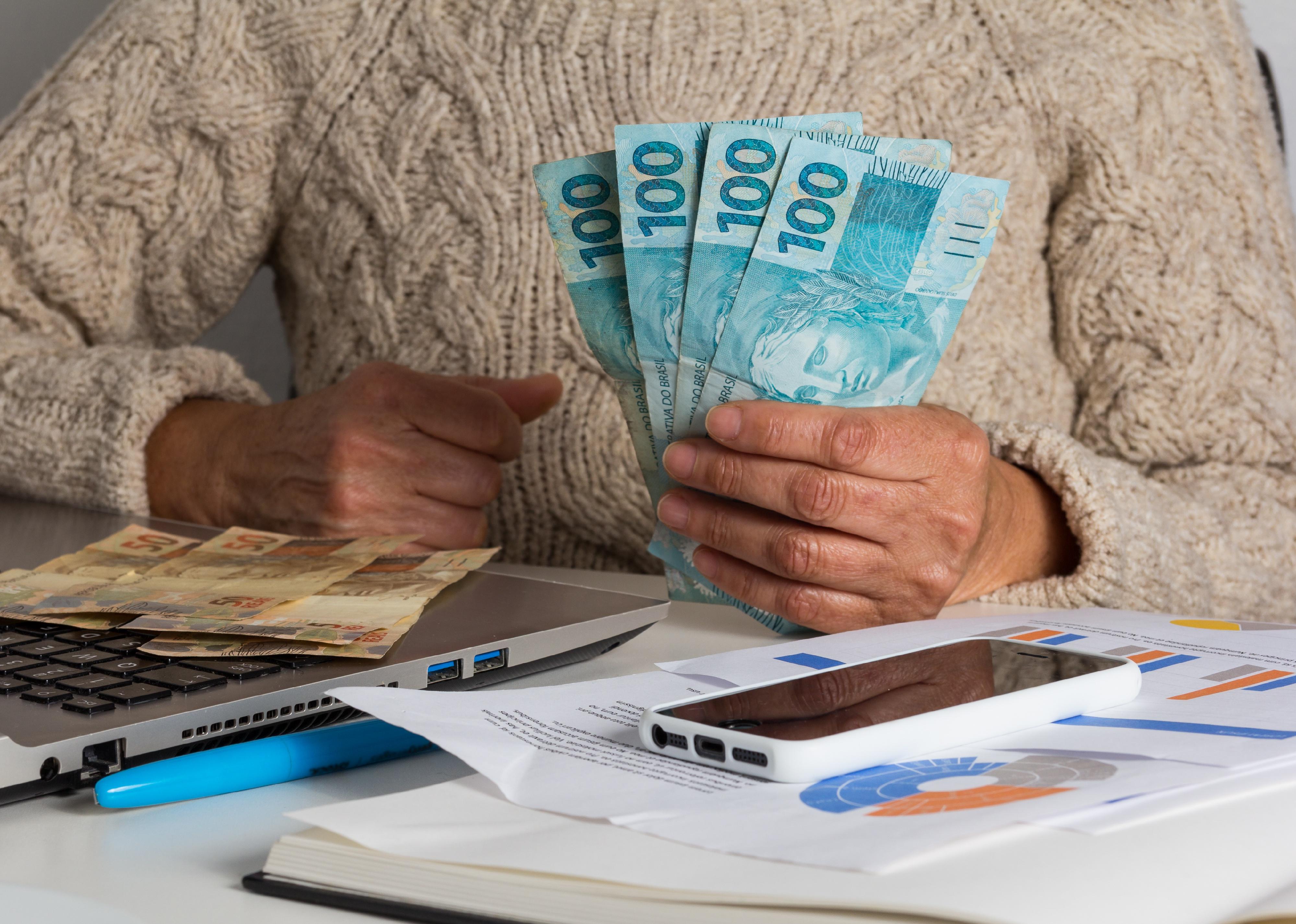 Close-up of woman's hands holding bills