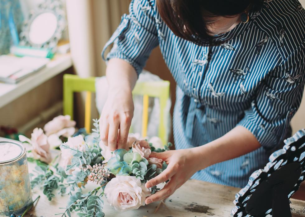 Female in a flower shop makes a bouquet