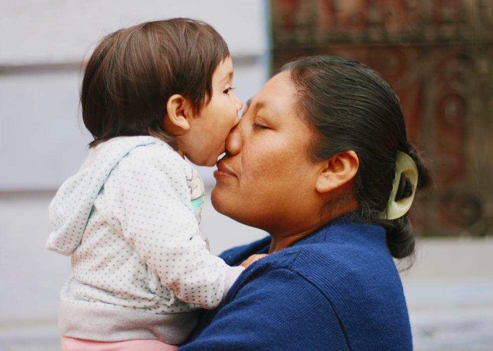 Side view of woman playing with daughter