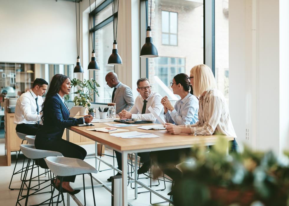 Smiling group having a meeting around a table in a modern office