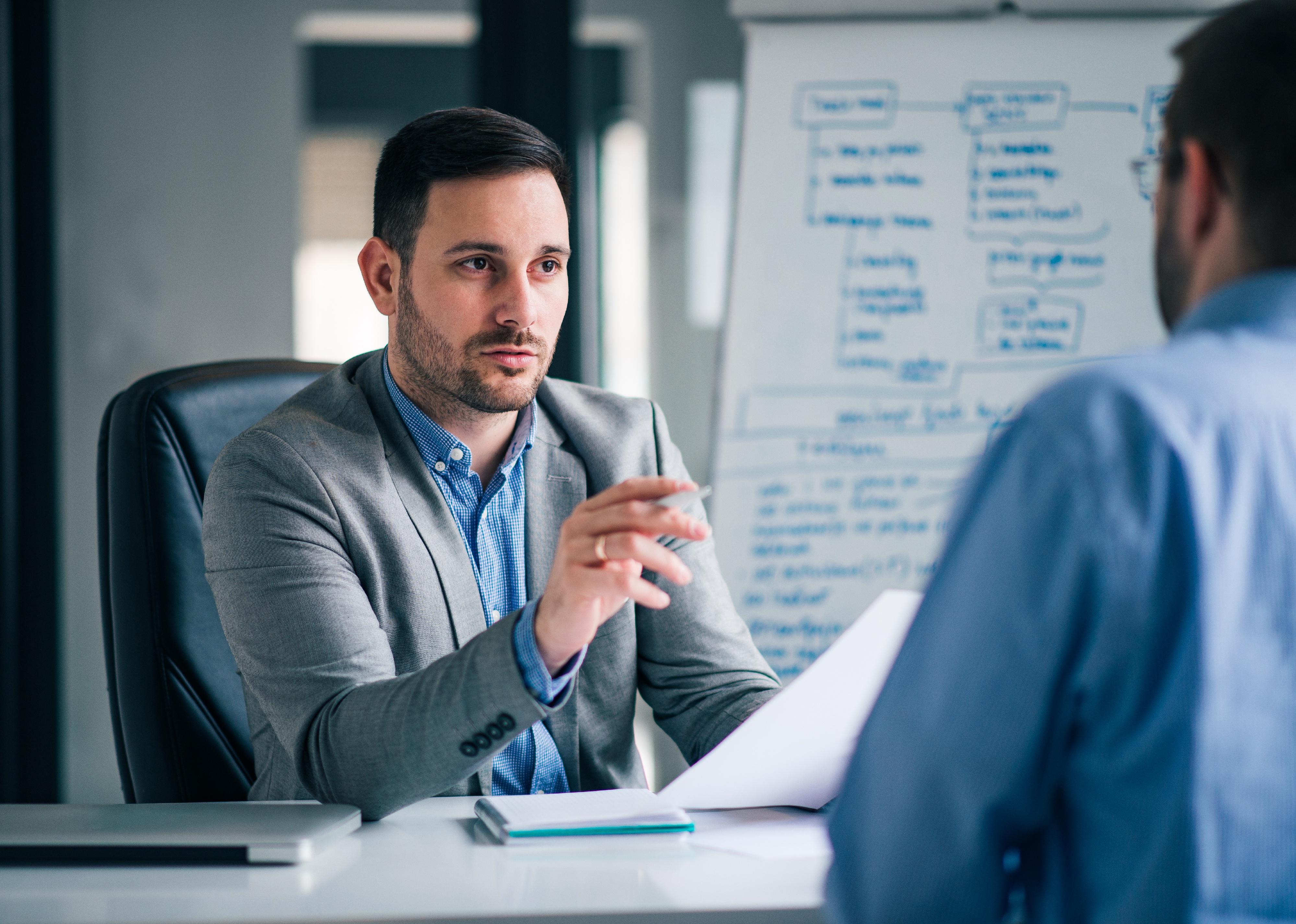 Man interviewing another man in an office