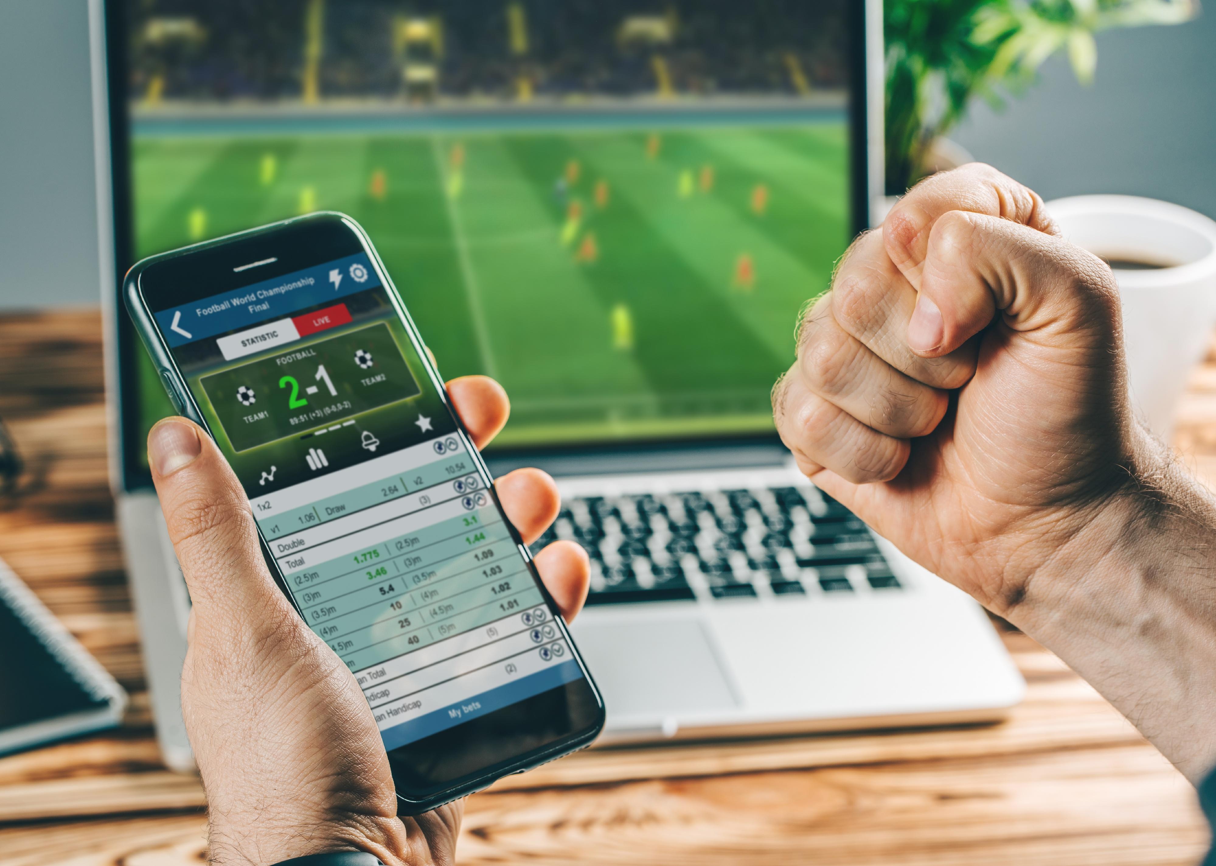 Person watching football play online broadcast on their laptop.