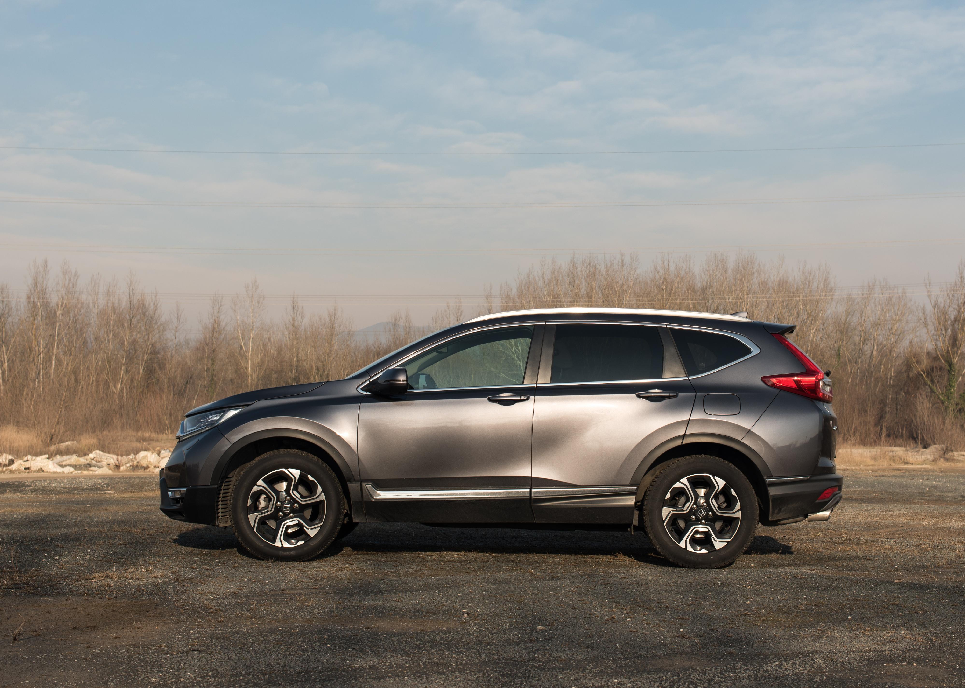 A Grey Honda CR-V 4x4 in nature with blue sky in background.