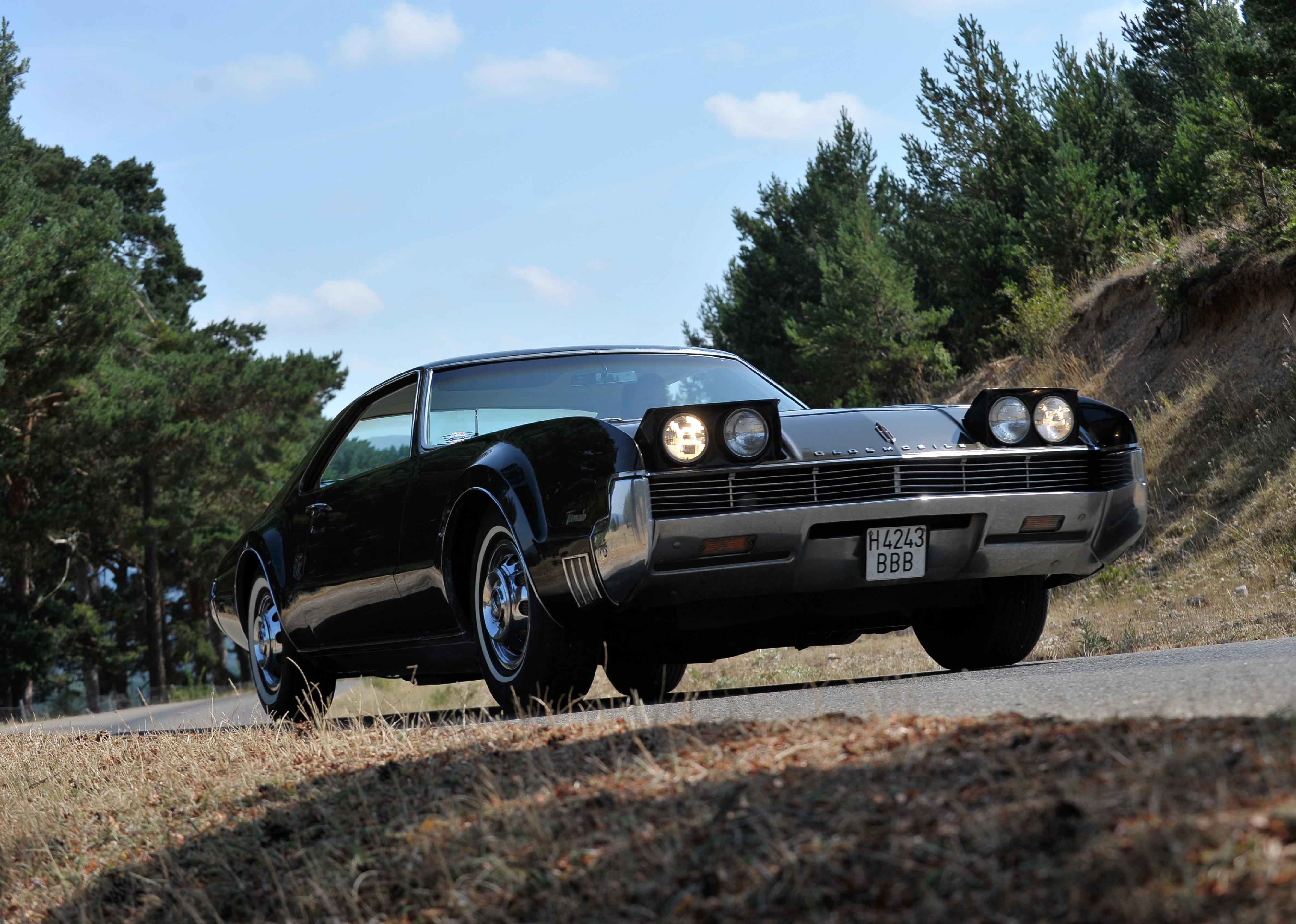An Oldsmobile Toronado on the road.