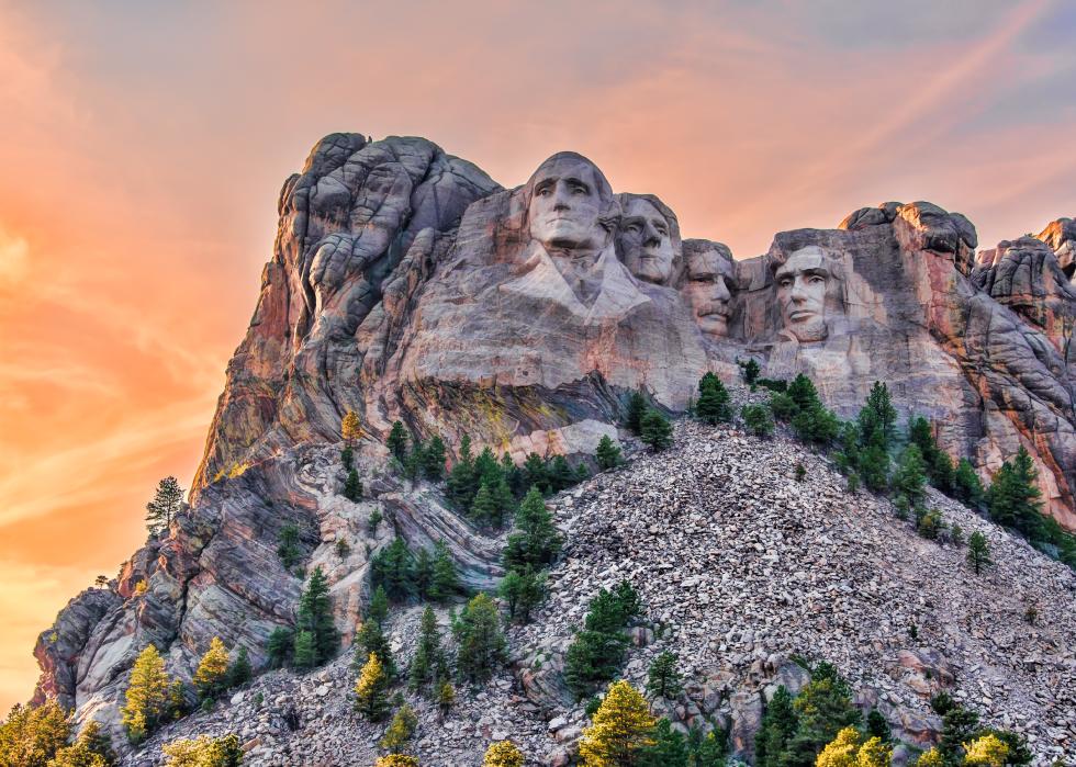Mount Rushmore with orange sky.