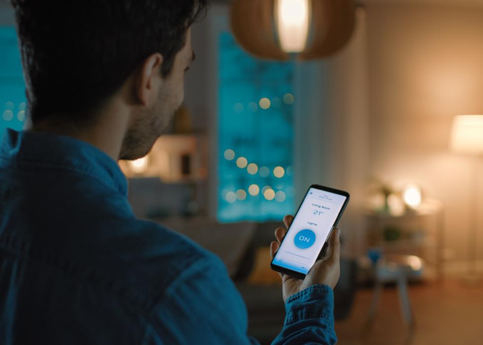 Man with app controlling lights