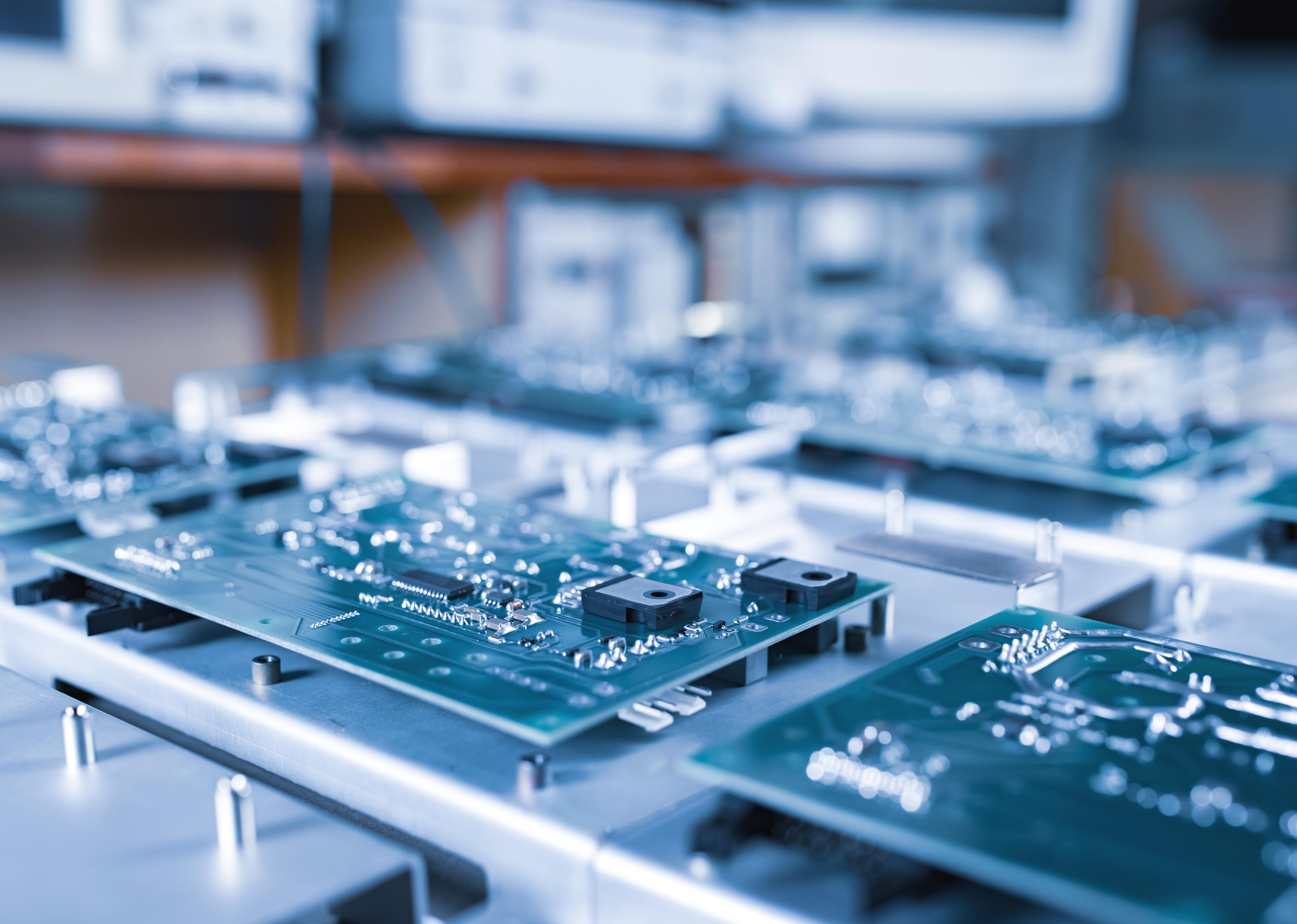 Close-up computer green microcircuits lie in a row in the production of computers.