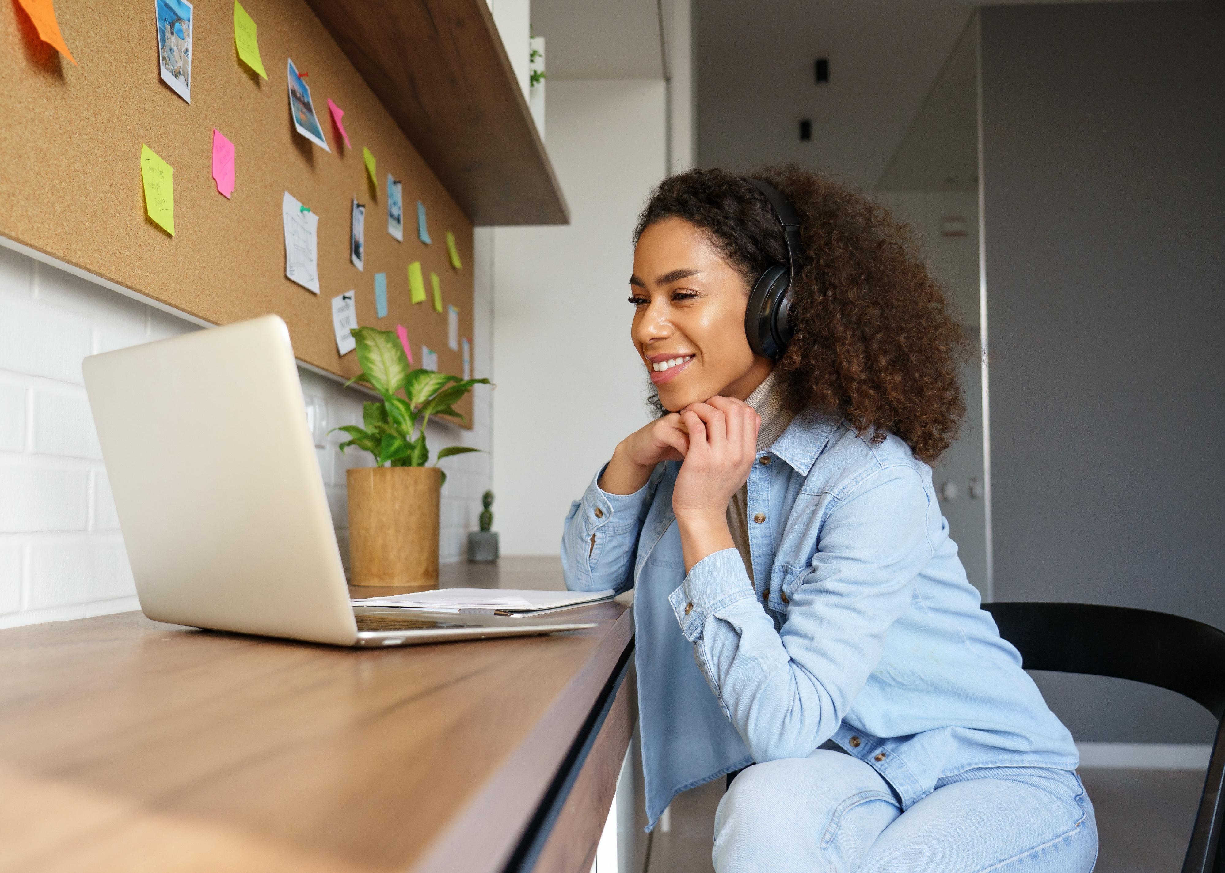 Young woman smiling at video call on laptop
