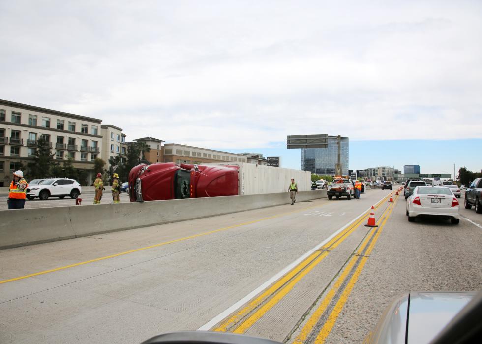 Semi truck and cargo on its side on the freeway after an accident