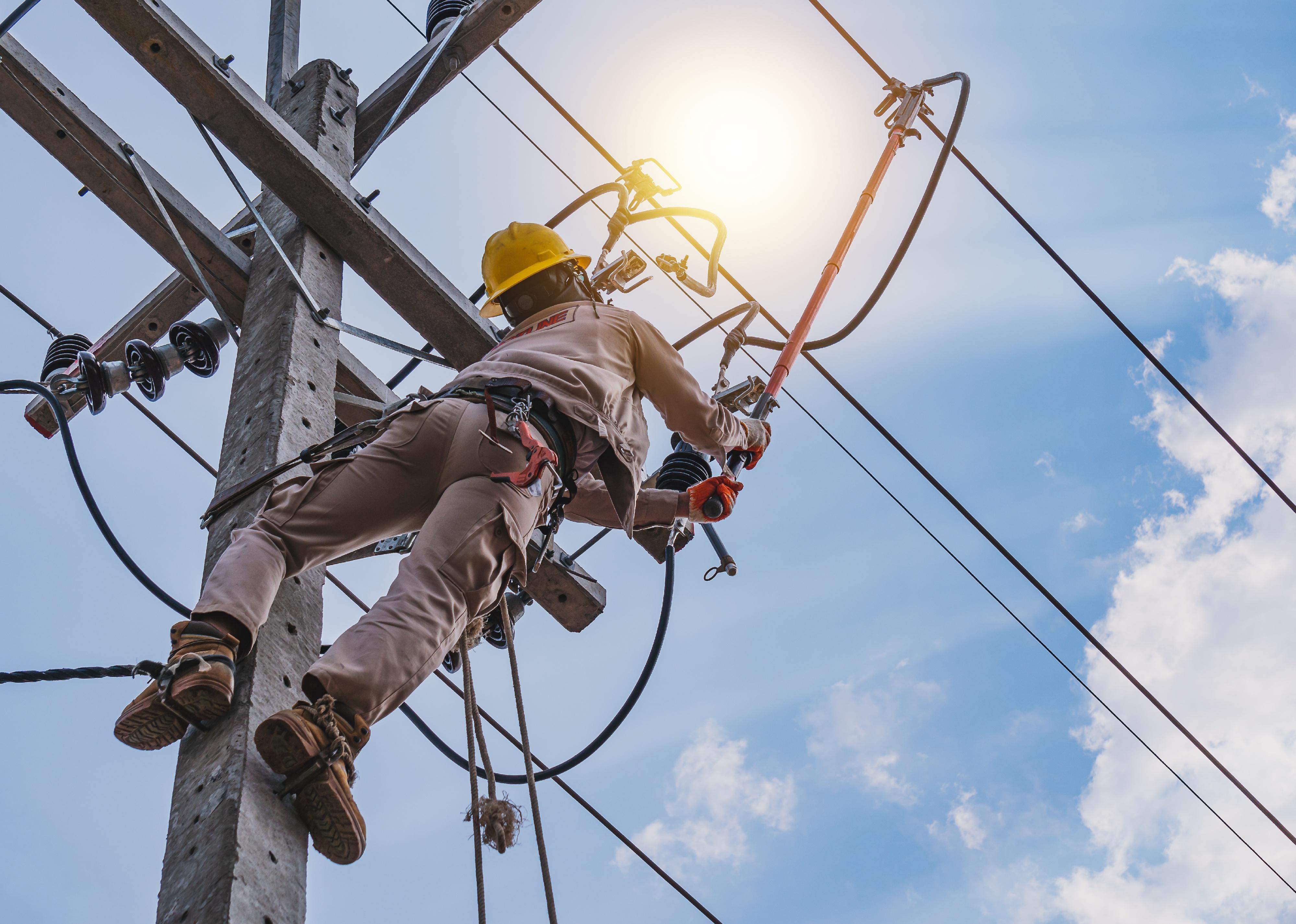 Power lineman use clamp stick (insulated tool) to closing a transformer.