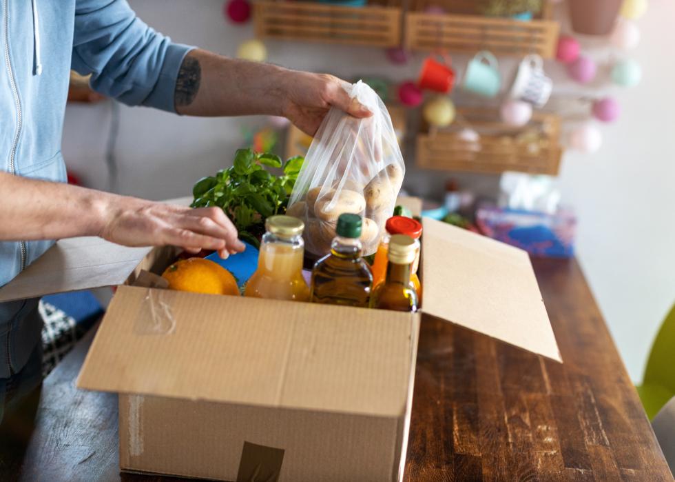Man checking his food delivery from a box