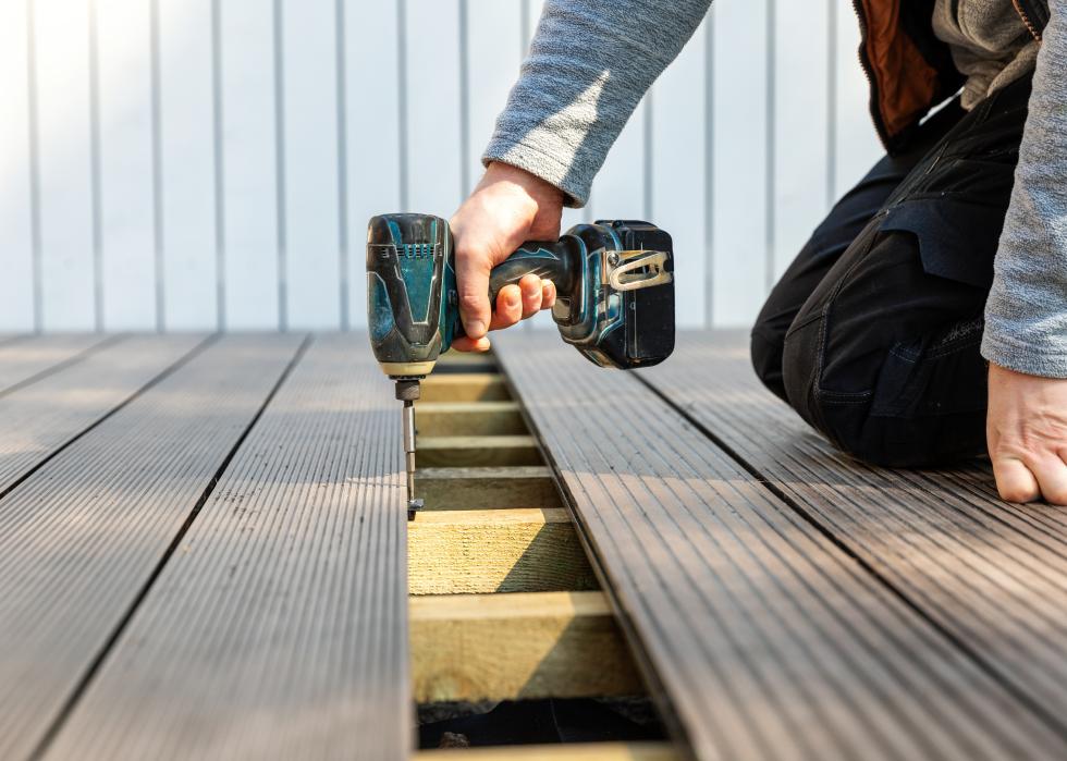 Man installing wpc composite decking boards.