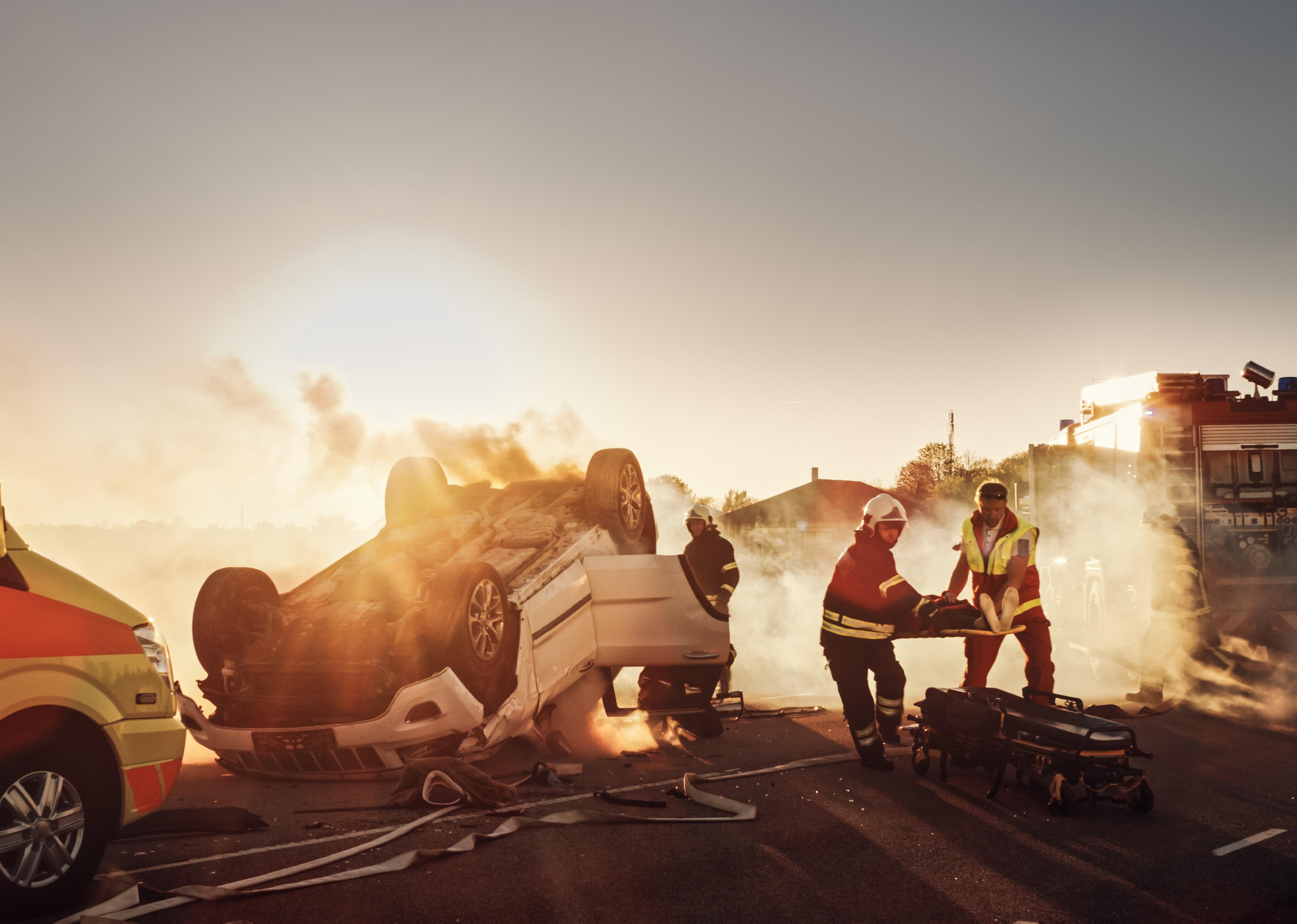 Scene of a car crash with paramedics.